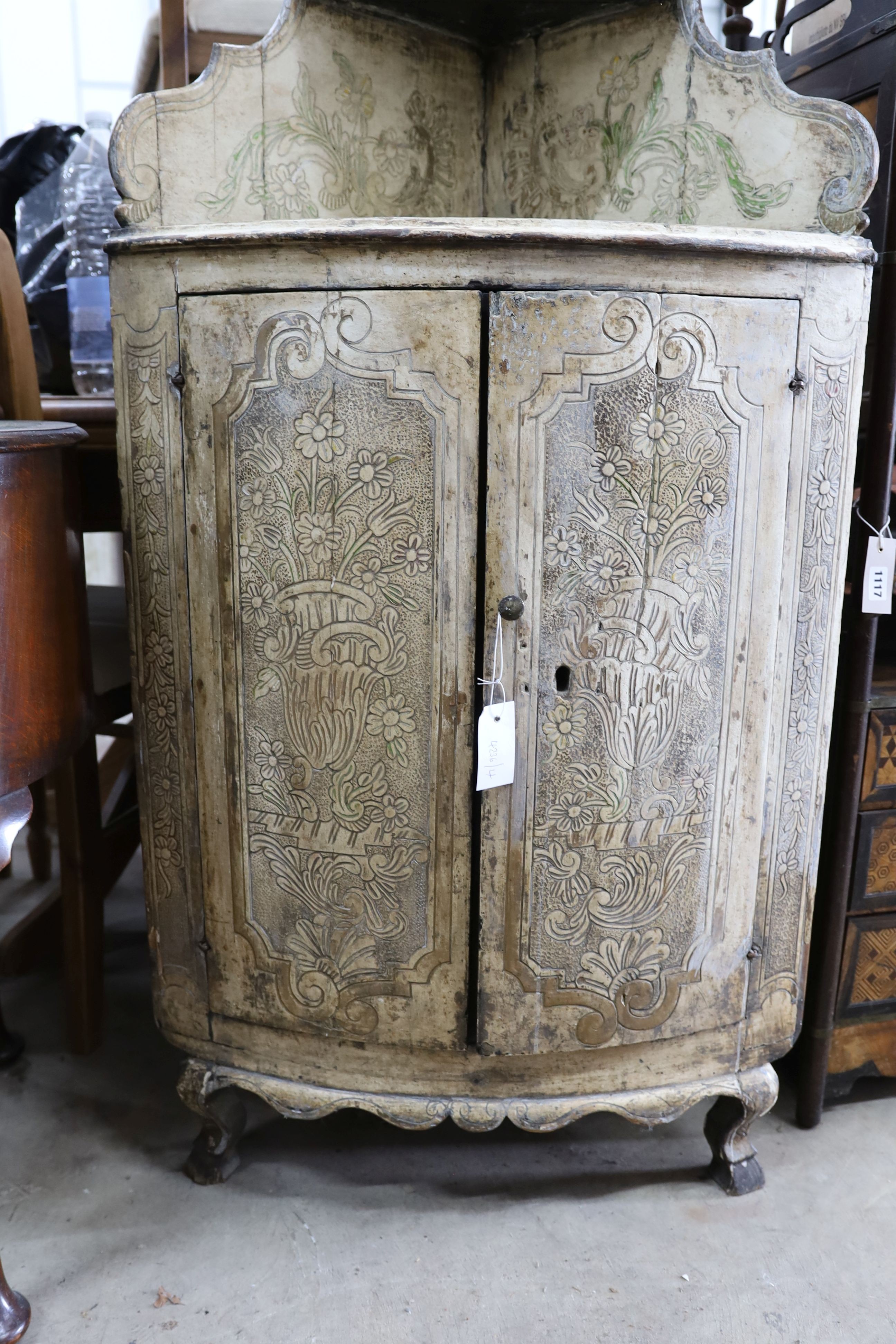 An 18th century Italian painted carved pine bow front standing corner cabinet, width 64cm, depth 38cm, height 145cm